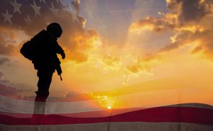Double exposure Silhouette of Soldier on the United States flag in sunset for Veterans Day is an official USA public holiday